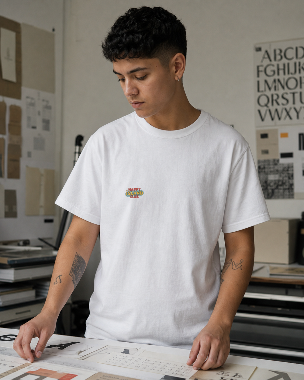 Puerto Rican adult wearing Algaro Tee with Red Chevron in a relaxed creative setting