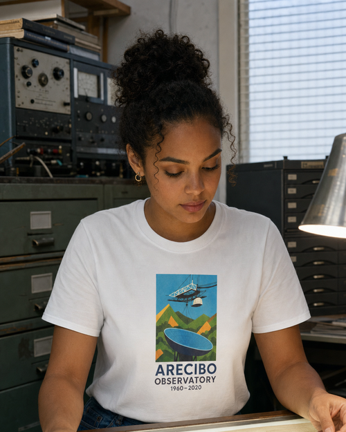 Puerto Rican adult wearing ARECIBO OBSERVATORY 1960–2020 T-Shirt in a relaxed creative setting