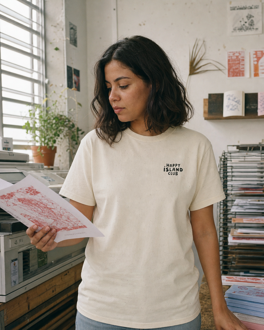 Puerto Rican adult wearing Pégate T-shirt in a relaxed creative setting