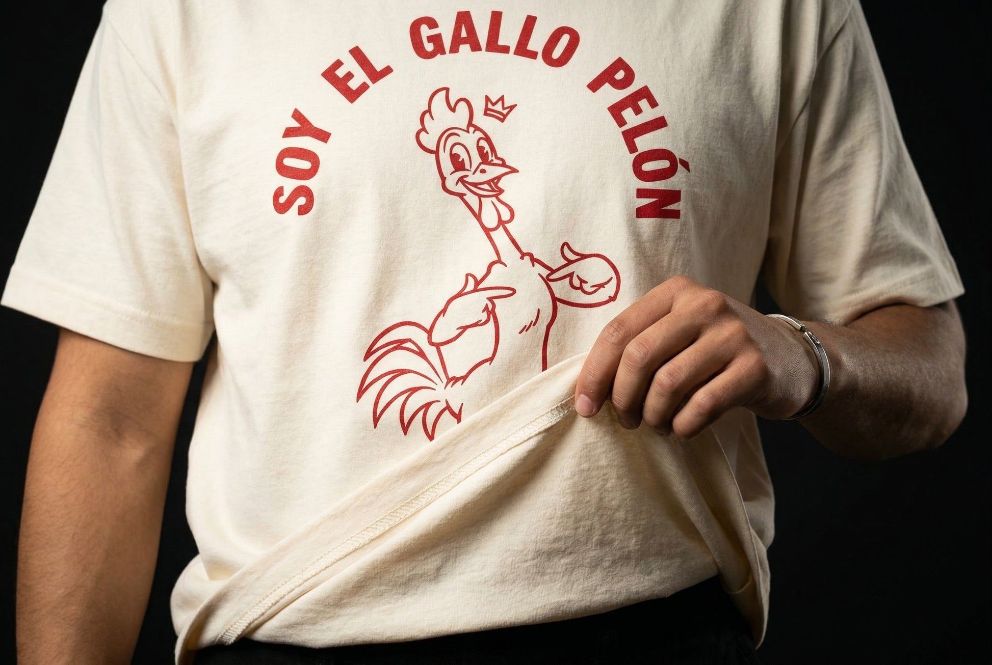 Soy El Gallo Pelón T-Shirt — soy-el-gallo-pel-n-t-shirt-studio-05-hem-hand